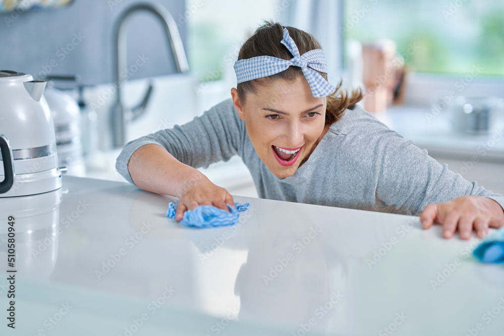 Young woman cleaning dirt in the kitchen Young woman cleaning dirt in the kitchen