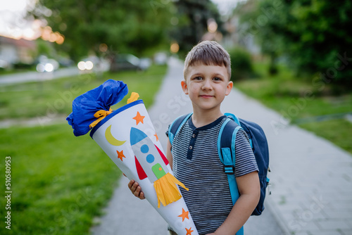 Принти на полотні Little kid boy with school satchel on first day of school, holding school cone w