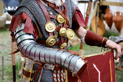 Legionary of Ancient Rome, close up of armor and scutum of infantry of Roman army on historical reconstruction festival photo