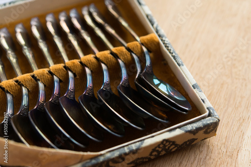 Vintage spoons on a wooden background. Perfect as a design element for menus and signs for cafes and restaurants.