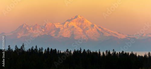 Panorama image of the glacier capped Mount Redoubt volcano from Anchor Point, Homer at sunrise