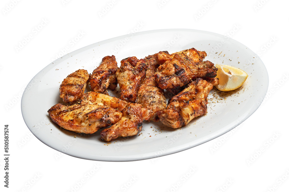 White plate with roasted chicken wings. White plate with roasted chicken wings.