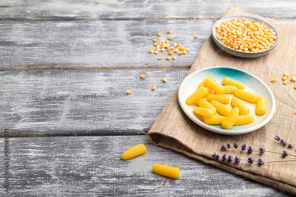 Jelly corn candies on gray wooden background. copy space, side view. Jelly corn candies on gray wooden background. copy space, side view.