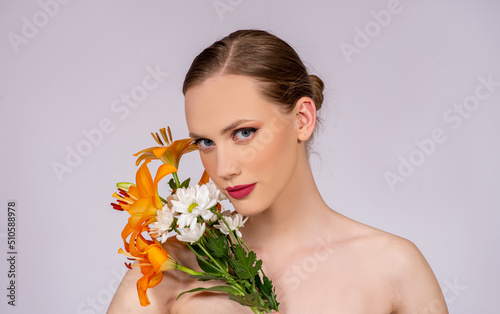 spring-summer make up colors, portrait of beautiful blond Caucasian woman with blossom flowers. Editorial series print ready, skincare and beauty concept
