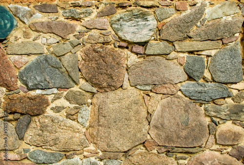 old wall made of colorful field stones