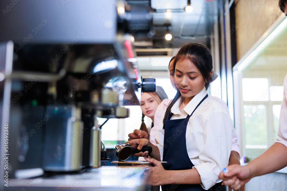 Barista learning make coffee by espresso machine. Group schoolgirl