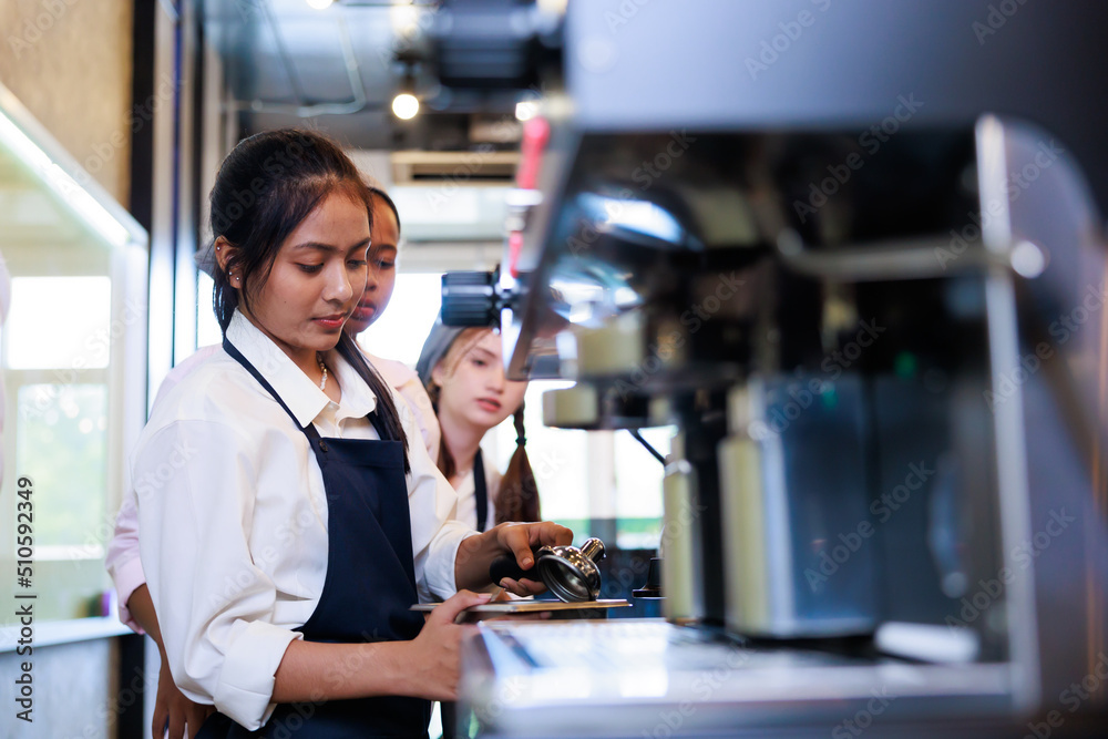 Barista learning make coffee by espresso machine. Group schoolgirl