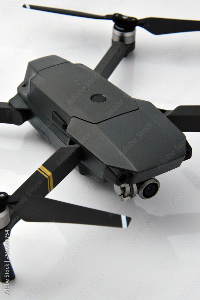 A gray camouflaged drone with a camera used for military espionage isolated.