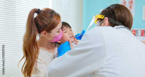 dentist examining toothache boy