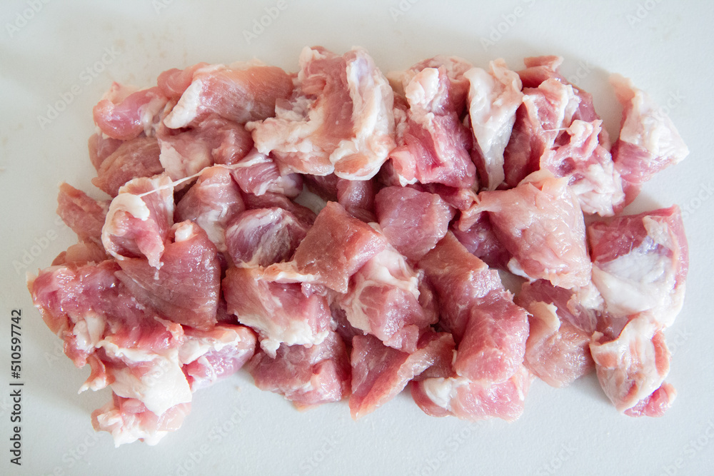raw pork chops on white