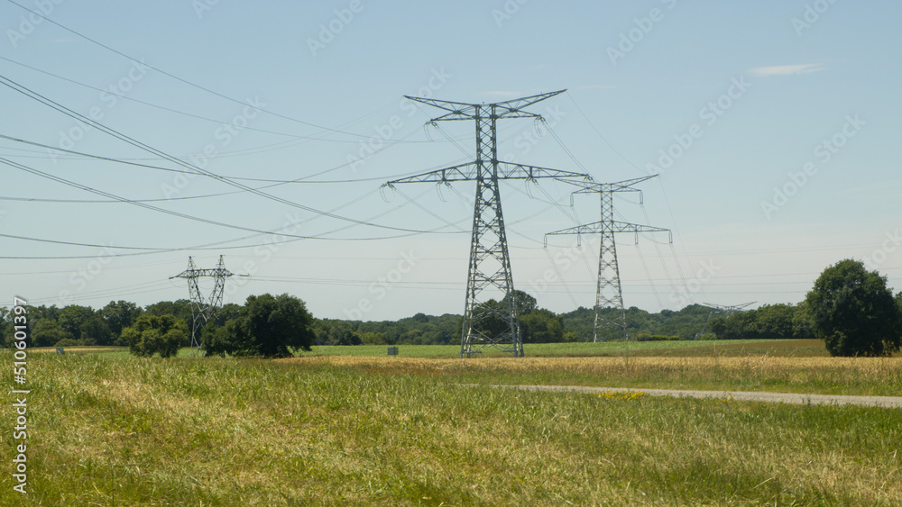 pylônes électriques dans des champs . lignes haute tensions a la campagne sous un ciel bleue pylônes électriques dans des champs . lignes haute tensions a la campagne sous un ciel bleue