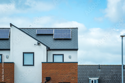 Solar panels mounted on the roof of a modern new-build house in England UK
