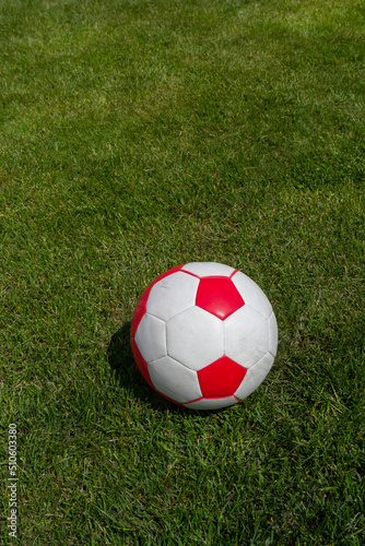 Soccer ball on green grass of football field with copy space