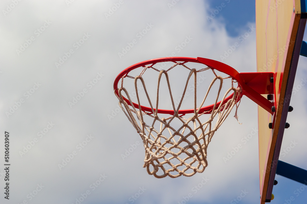 Photo of glass basketball hoop and blue sky background,basketball basket
