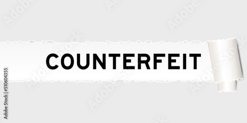 Ripped gray paper background that have word counterfeit under torn part