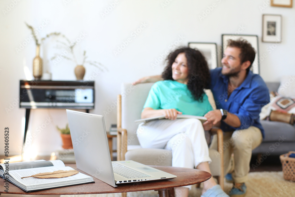 Young couple with a laptop and mobile phone sitting on the floor at home
Young couple with a laptop and mobile phone sitting on the floor at home