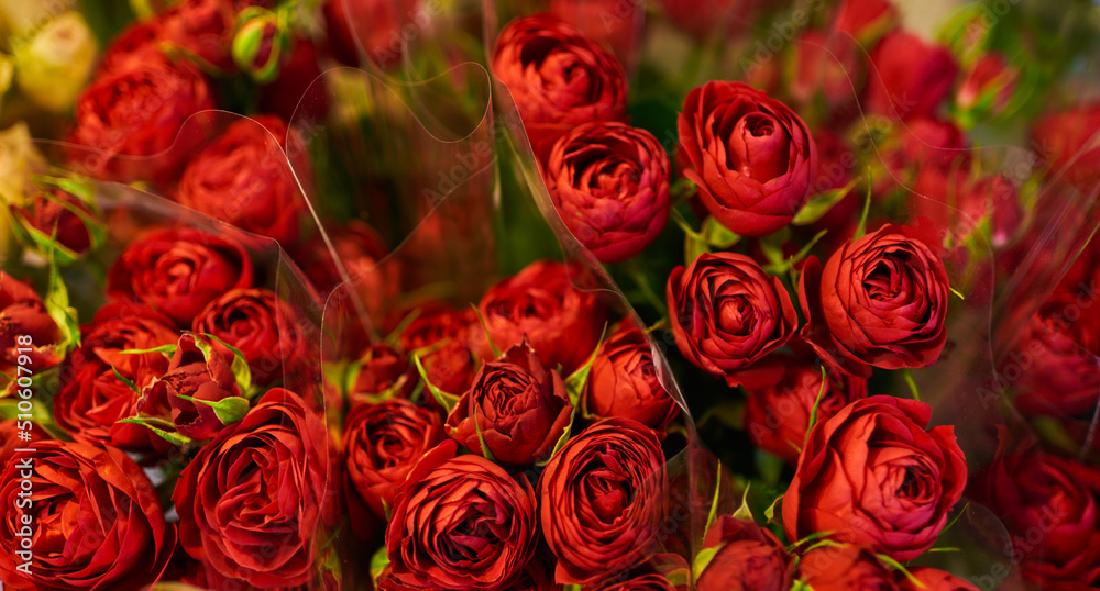 Beautiful bouquets of red roses in a flower shop. Background on full screen. Handsome fresh bouquets. Flowers delivery. Floral shop concept. Selective focus. Beautiful bouquets of red roses in a flower shop. Background on full screen. Handsome fresh bouquets. Flowers delivery. Floral shop concept. Selective focus.