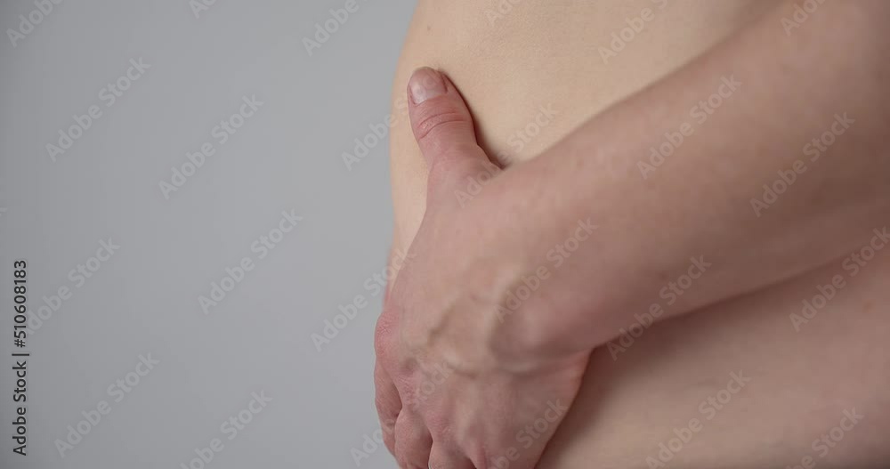 Close up slow motion, overweight unhealthy person squeezing belly fat, side view Close up slow motion, overweight unhealthy person squeezing belly fat, side view