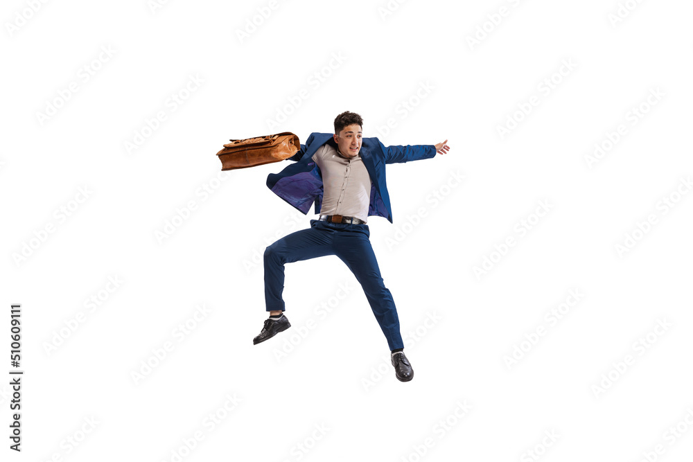 Portrait of young man. office worker in official suit, jumping over with suitcase isolated over white studio background Portrait of young man. office worker in official suit, jumping over with suitcase isolated over white studio background