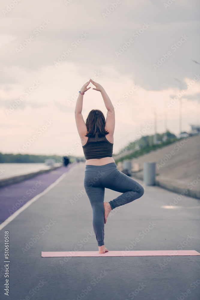 girl child teenager in sportswear with excess weight does exercises, plays sports outside in summer. girl child teenager in sportswear with excess weight does exercises, plays sports outside in summer.