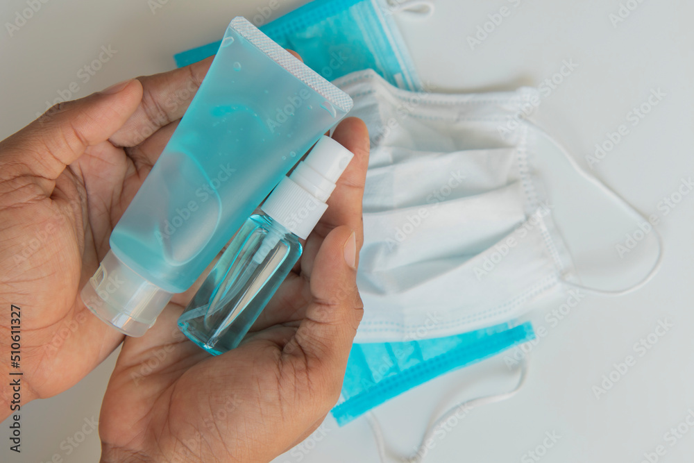 Fototapeta premium Blue hand washing gel and hand spray with mask on white background for clean and prevent germs from viruses