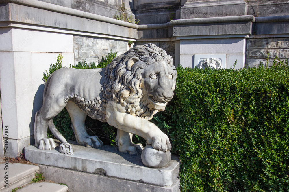 Ancient marble statue of lion in a palace garden