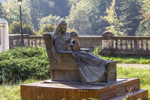 Metal statue of grandmother in palace garden