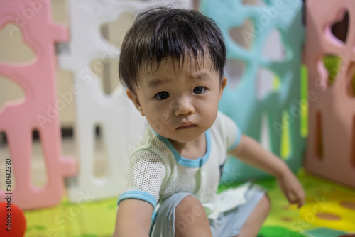 Portrait image of​ 1-2 years old​ childhood​ child. Face of relax and happy Asian​ boy in head shot.