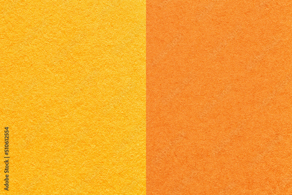 Texture of craft yellow and orange paper background, half two colors, macro. Structure of vintage cardboard. Texture of craft yellow and orange paper background, half two colors, macro. Structure of vintage cardboard.