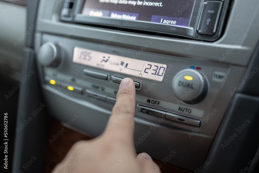 Man hand press and adjust Air conditioner control in luxury car interior Man hand press and adjust Air conditioner control in luxury car interior