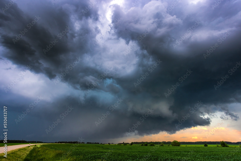 Storm clouds over field, tornadic supercell, extreme weather, dangerous storm Storm clouds over field, tornadic supercell, extreme weather, dangerous storm