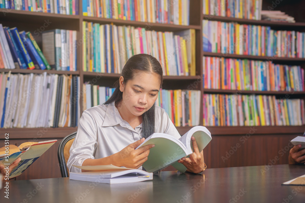 Asian college students sitting reading, studying, examining, Tutor books with friends. People learning education concept Asian college students sitting reading, studying, examining, Tutor books with friends. People learning education concept