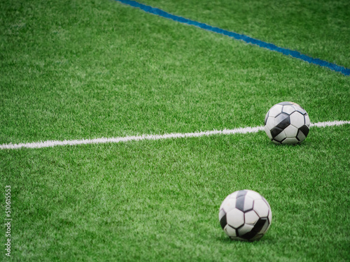 soccer balls on top of the artificial grass © 23_stockphotography