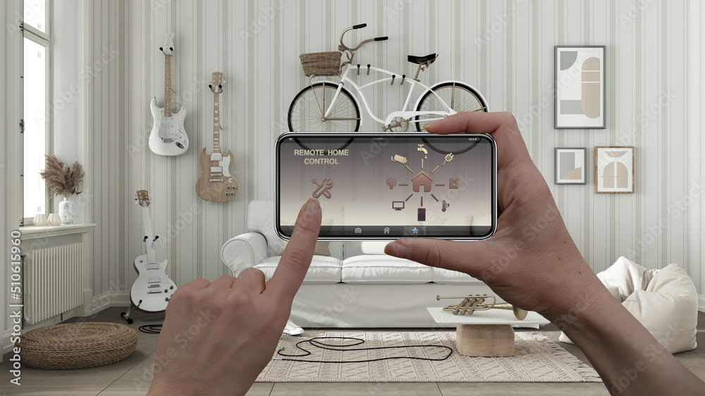 Remote home control system on a digital smart phone tablet. Device with app icons. Interior of scandinavian living room in white tones with sofa in the background, architecture design Remote home control system on a digital smart phone tablet. Device with app icons. Interior of scandinavian living room in white tones with sofa in the background, architecture design