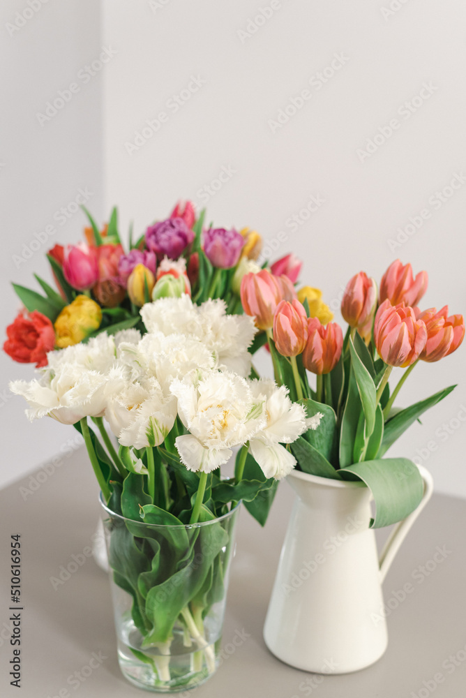 Lovely bouquets of tulips in vases on the table. Lovely bouquets of tulips in vases on the table.