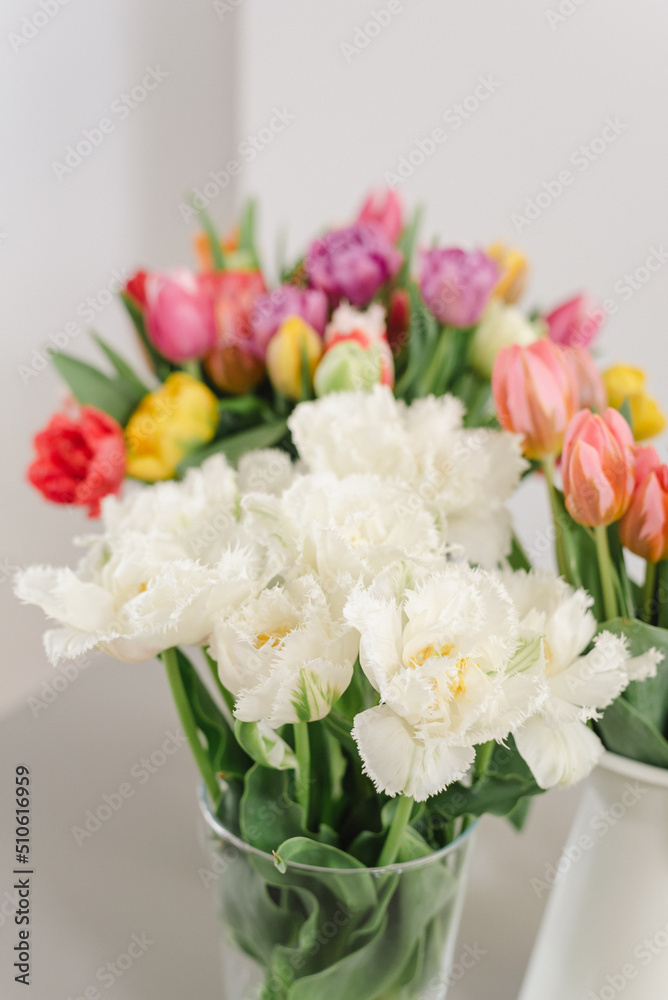 Lovely bouquets of tulips in vases on the table. Lovely bouquets of tulips in vases on the table.