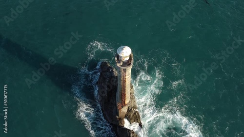 Descending to reveal the Karori Rock Lighthouse in the Cook Strait, New Zealand photo