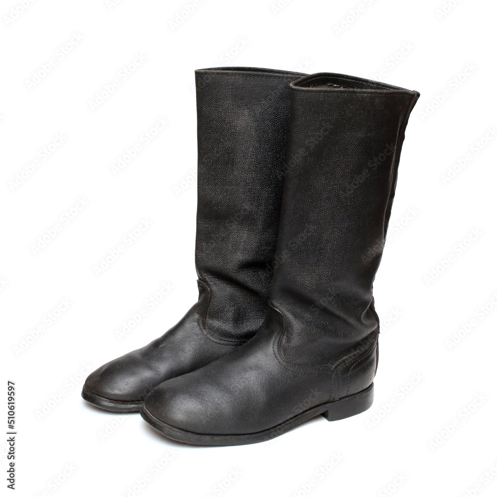Old military boots made of leather on white background, black army boots isolated on white, combat and ceremonial shoes of a soldier of the army of the Soviet Union