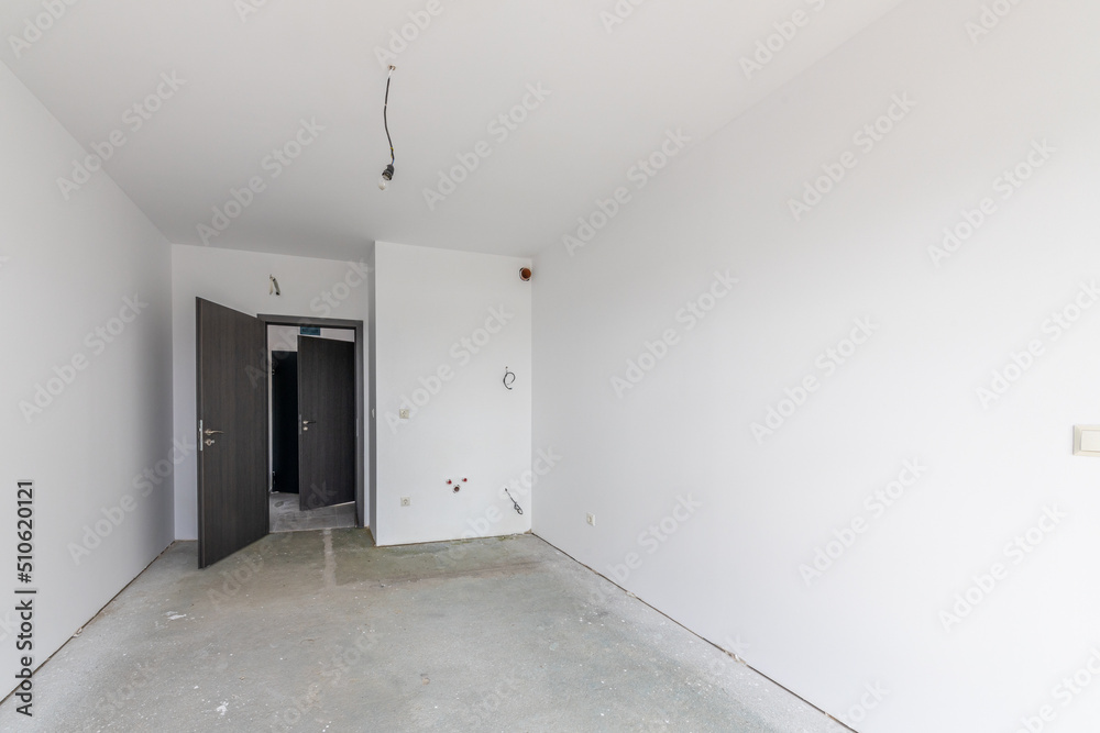New empty room under construction. Plaster walls. New home. Concrete walls. Interior renovation. New empty room under construction. Plaster walls. New home. Concrete walls. Interior renovation.