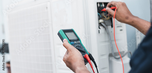 Air conditioner technicians use a multimeter to check electricity and Part of the preparation to install a new air conditioner.