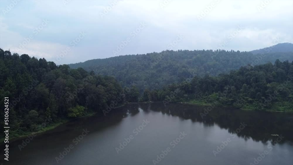 Aerial View Fly over Lake towards hills and mountains in Sukabumi, Indonesia Aerial View Fly over Lake towards hills and mountains in Sukabumi, Indonesia