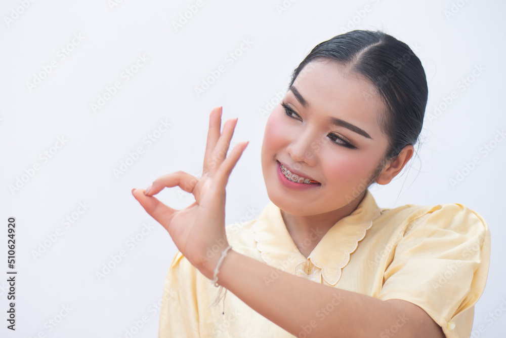 Woman pointing up accepting ok hand gesture to blank space Woman pointing up accepting ok hand gesture to blank space