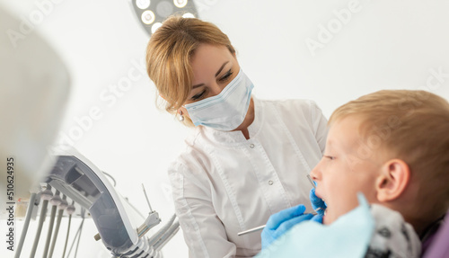 Beautiful kid boy in dentist s chair the office treats teeth