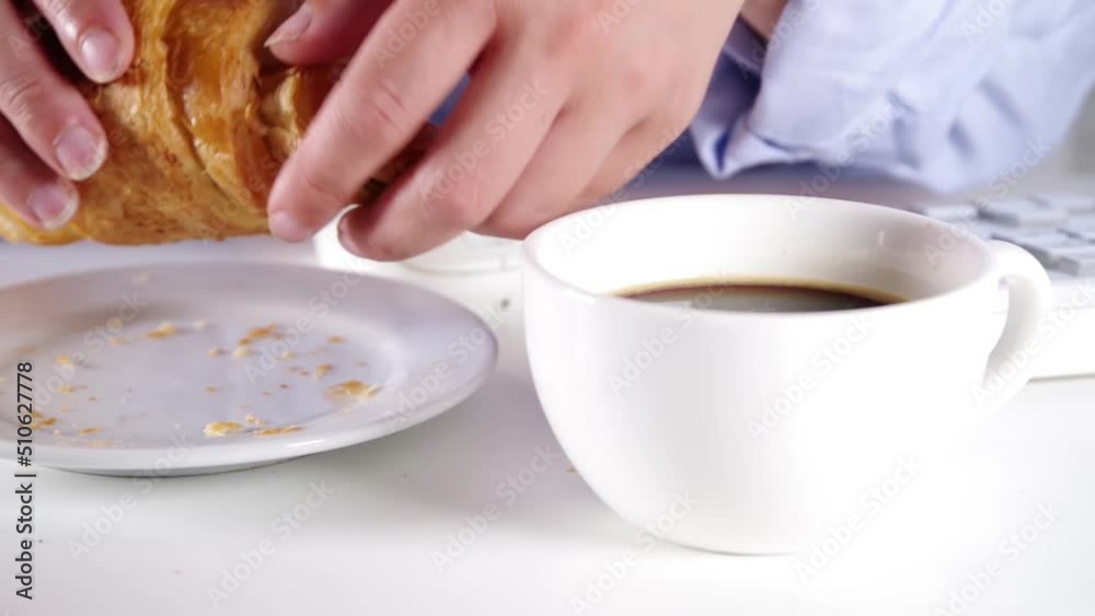 Close-up video of unrecognizable caucasian woman drinks coffee, eating french croissant with coffee espresso. Dipping croissant in coffee. Coffee break concept Close-up video of unrecognizable caucasian woman drinks coffee, eating french croissant with coffee espresso. Dipping croissant in coffee. Coffee break concept