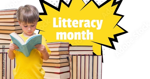 Composite of cute caucasian boy reading book and literacy month text with stack of books, copy space