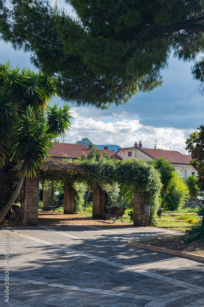 Small garden in the Italian province in the south. Beautiful arches with fresh flowers, comfort in the hot season.