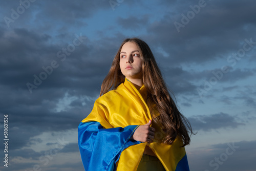 patriotic teen ukrainian kid with national flag of ukraine
