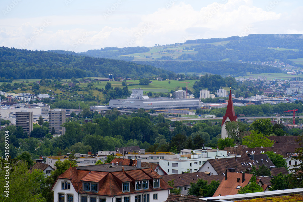 Aerial view over city of Zürich with mountains in the background seen from district Höngg on a cloudy summer day. Photo taken June 5th, 2022, Zurich, Switzerland.
