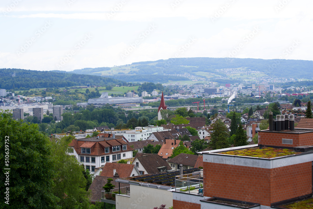 Aerial view over city of Zürich with mountains in the background seen from district Höngg on a cloudy summer day. Photo taken June 5th, 2022, Zurich, Switzerland.