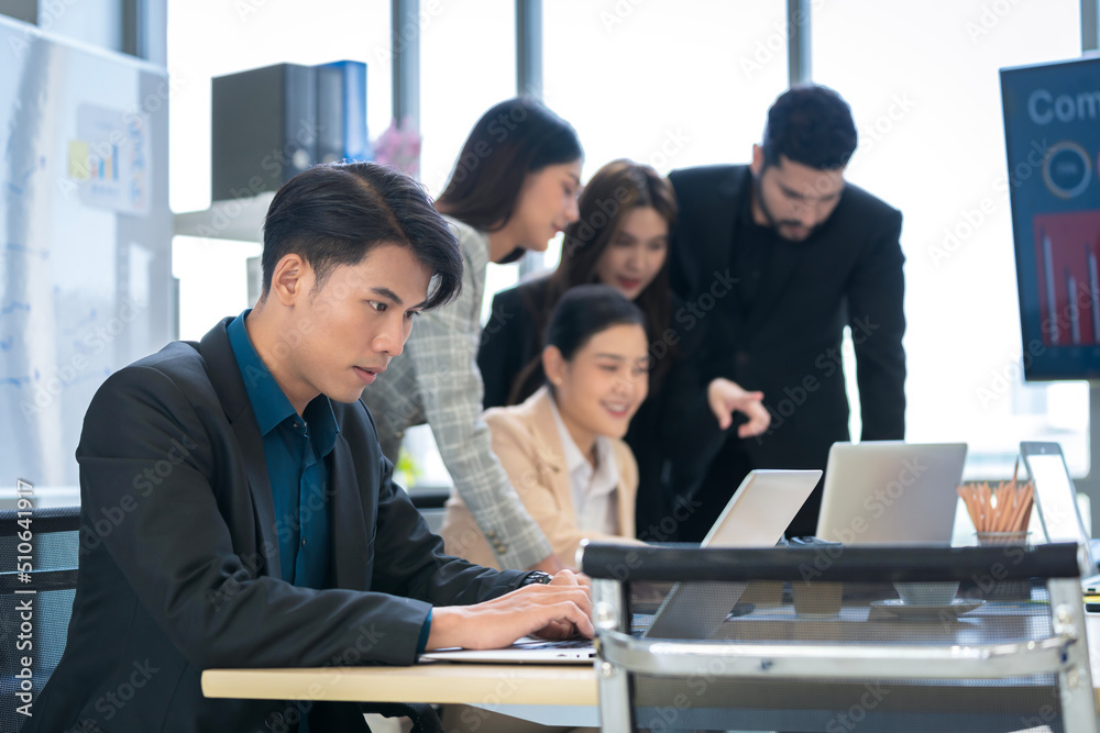 Asian businessman Working and meeting at the office at the company with colleagues at the back Asian businessman Working and meeting at the office at the company with colleagues at the back